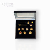 Set of gold crown-shaped jewelry in a black display box with 'Crowns & Regalia' branding.